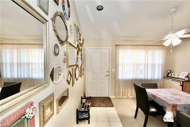 Tiled foyer featuring ceiling fan