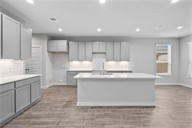 This kitchen is by far any chef’s dream! This spacious kitchen features high ceilings, stained wood cabinets, quartz countertops, SS appliances, modern tile backsplash, recessed lighting, extended counter space, granite kitchen island with space for breakfast bar, and a walk-in pantry all overlooking your huge family room.