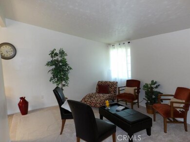 Living room with high ceiling, new carpet with anti-microbial padding, new double pane window.