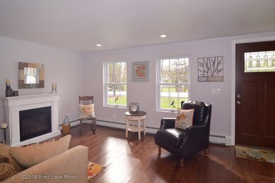 Light and bright living room with gleaming hardwoo