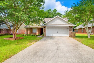 Single story home featuring brick siding, an attac