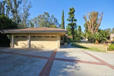 Three car garage with additional parking spaces.
