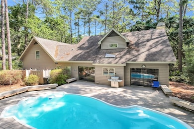 Back of home with a private pool