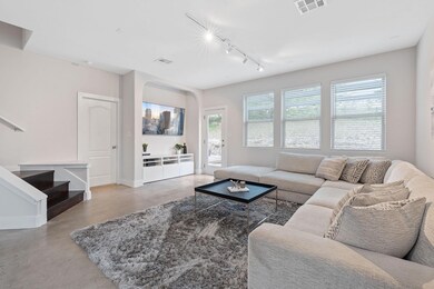 Living room with concrete floors, track lighting,