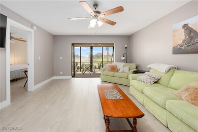 Living room with light hardwood / wood-style floor