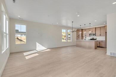Unfurnished living room featuring a chandelier, recessed lighting, and light wood-type flooring