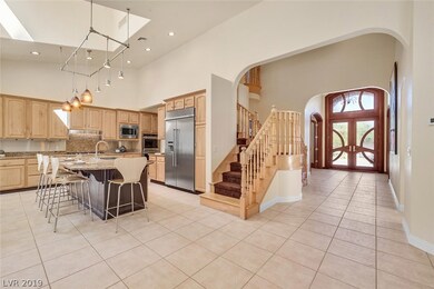 Light, bright open kitchen with custom lighting.