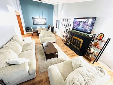 Living area with a fireplace and light wood-style floors