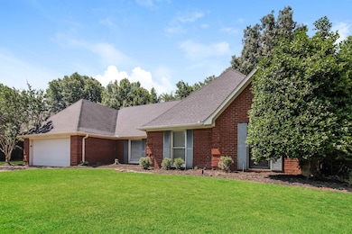 Single story home featuring a garage and a front l