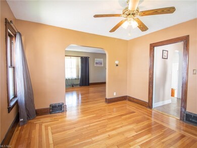 Formal dining room with hardwood floors.