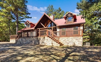 Log home featuring a wooden deck