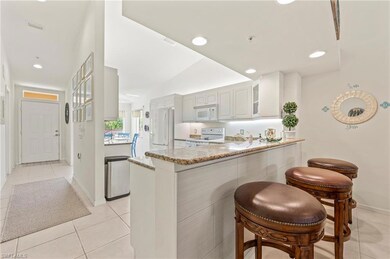Kitchen with recessed lighting, white appliances, 