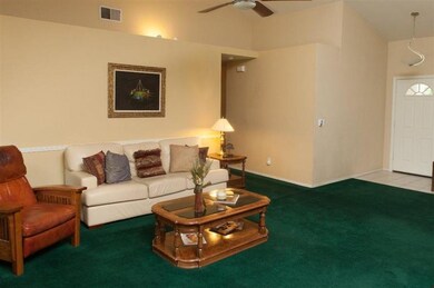 ANOTHER VIEW OFLIVING ROOM AND FRONT DOOR INTO HOM