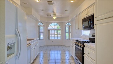 White cabinets, tile flooring and breakfast nook