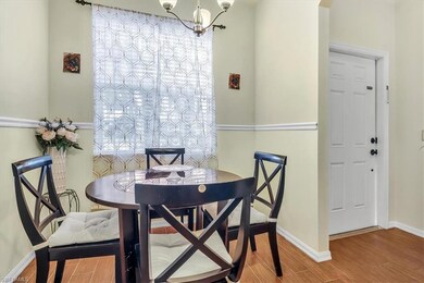 Dining room with an inviting chandelier and hardwo