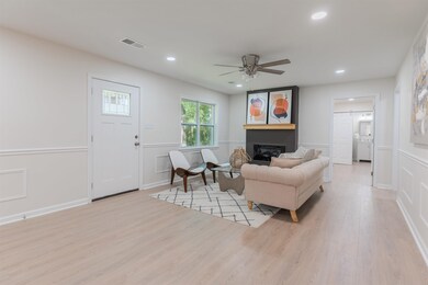 Living room featuring ceiling fan and light hardwo
