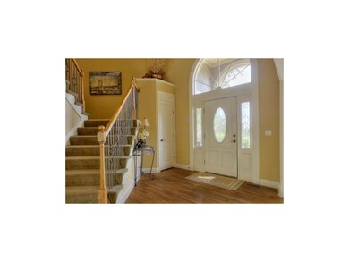 Grand entry with wrought iron staircase.