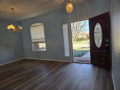 Entryway featuring a chandelier and dark hardwood 