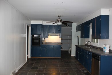 Large Open Kitchen/Dining Room Combination with Tile Flooring.