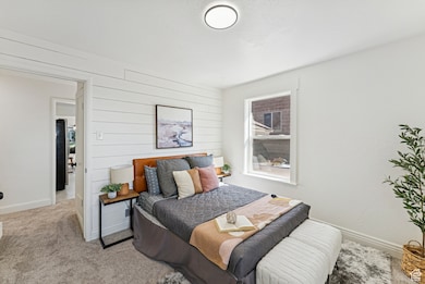 Bedroom with carpet and wooden feature wall
