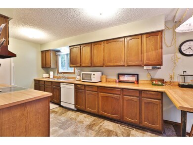 Light and bright kitchen has a breakfast bar and p