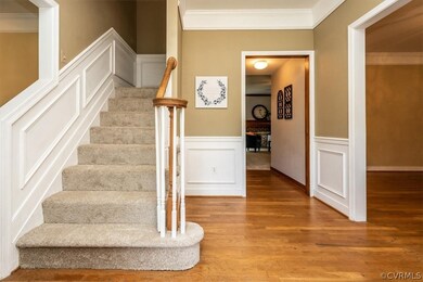 Stairs with hardwood / wood-style flooring and cro