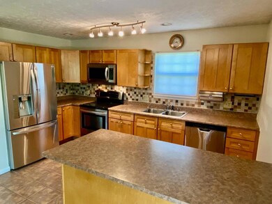 Wood cabinets and tiled backsplash.