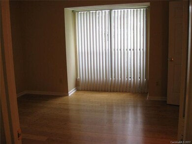 Spacious master bedroom with bamboo floors and wal