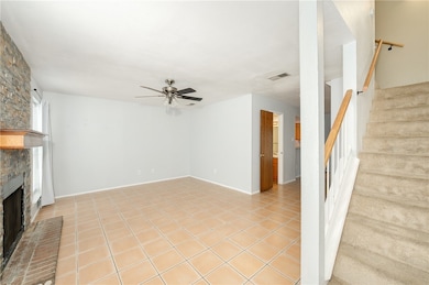 Unfurnished living room with ceiling fan, a large