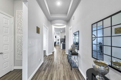 Formal entry with wood-look tile floors and rotunda.