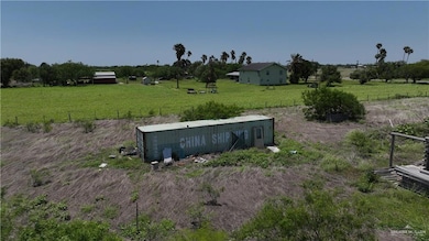 View of grassy yard featuring an outbuilding, a view of countryside, and an outdoor structure