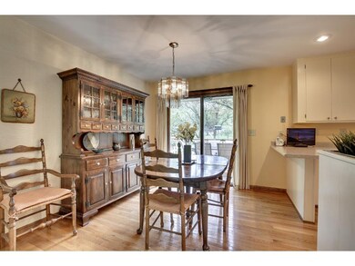 The dining room features hardwood floors, overhead