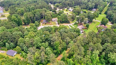 Aerial view of property's location featuring a forest
