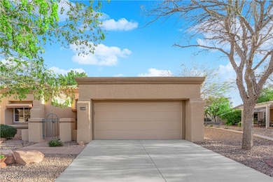 View of front of home with a garage, driveway, and