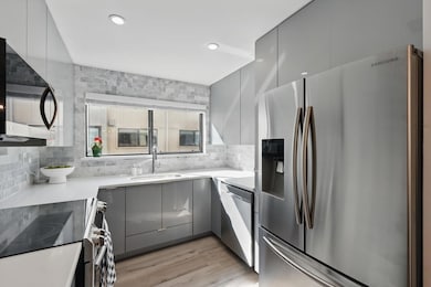 Kitchen with a sink, gray cabinets, modern cabinet