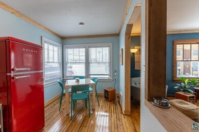 Dining space featuring crown molding and light har