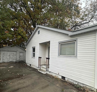 Back of house featuring an outdoor structure and a detached garage