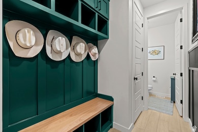 Mudroom featuring light floors and baseboards