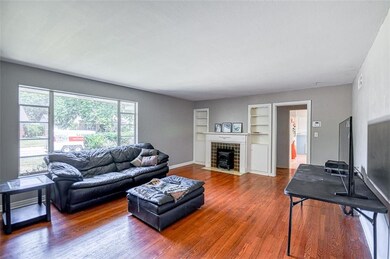 Living room with view of hallway to bedrooms and f