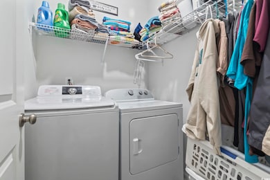 Laundry room with washing machine and clothes dryer