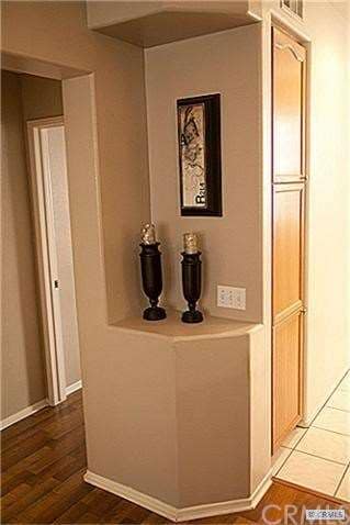 A built in shelf near the kitchen is perfect for a