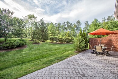 Full width paver patio with brick side privacy wal