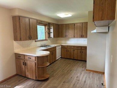Kitchen featuring backsplash, brown cabinets, ligh