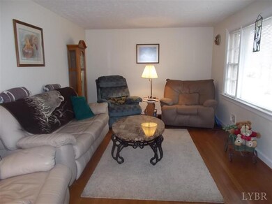 Nice hardwood floors in a spacious living room with a large picture window for plenty of light.