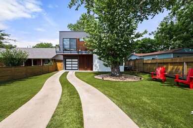 View of front of home with a garage, a balcony, f