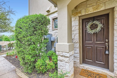 View of exterior entry with stone siding and stuc