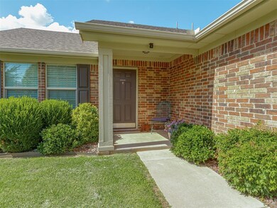 Property entrance with brick siding, a shingled roof, and a lawn