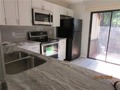 Kitchen opens to sliders to the back patio.