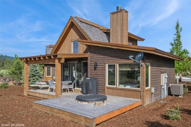 Rear view of property featuring central AC, a chimney, a wooden deck, and an outdoor hangout area