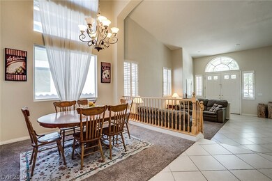 Formal dining room looks over formal living room.